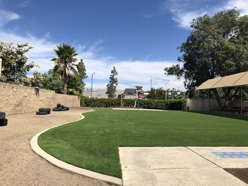 A large grassy area with a concrete walkway in the middle