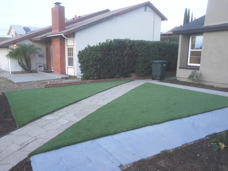 A house with a green lawn in front of it