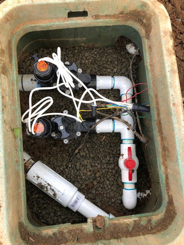 A box filled with a bunch of pipes and wires