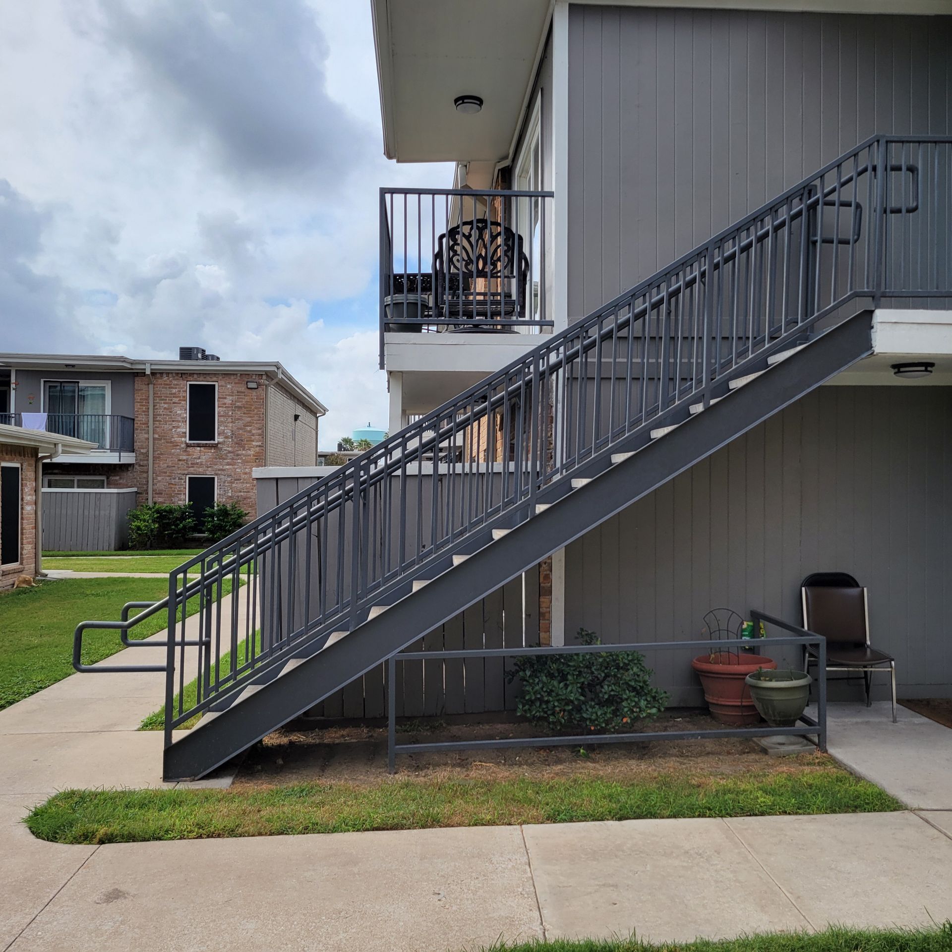 A building with stairs leading up to a balcony