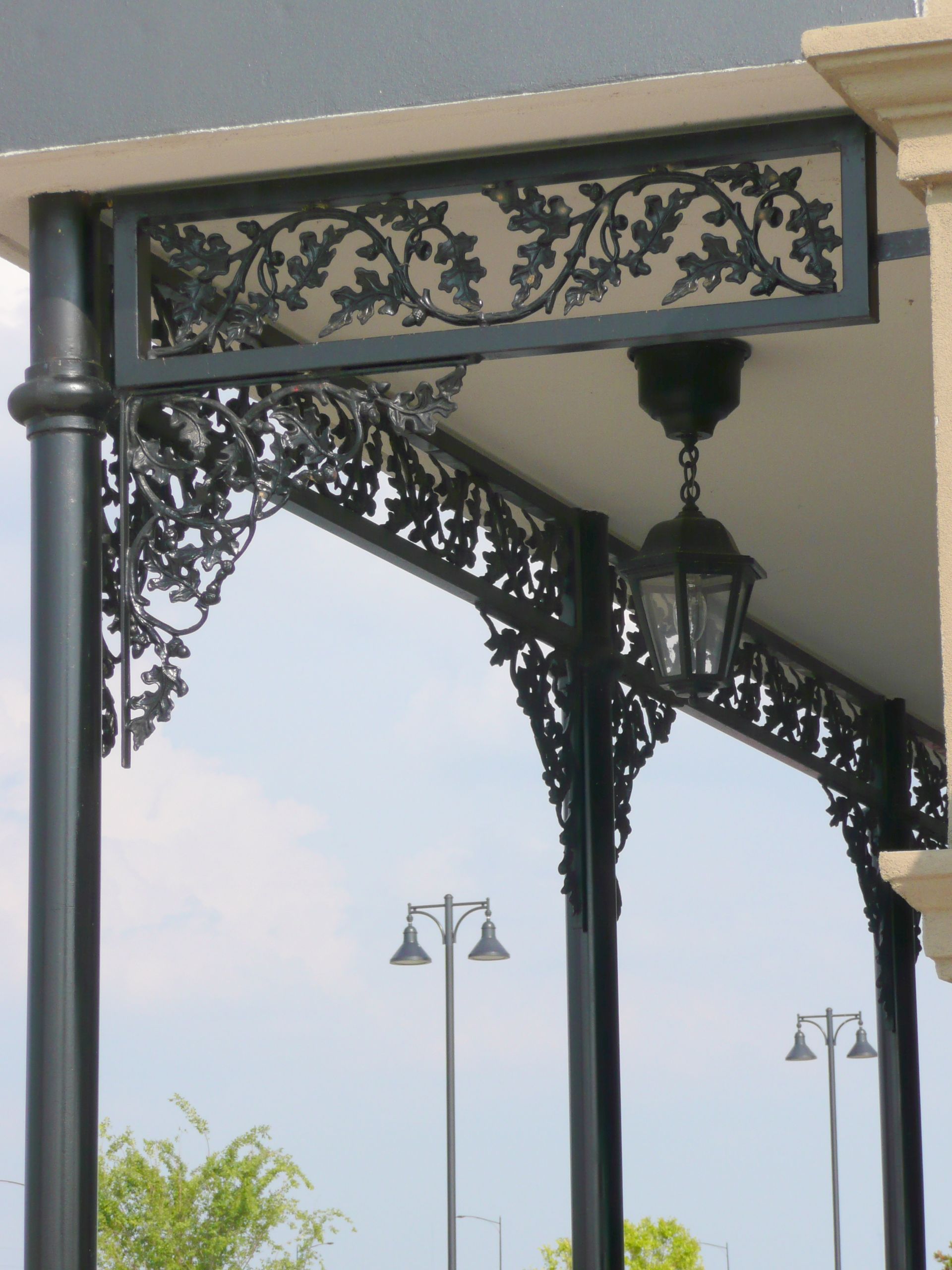 A porch with a lantern hanging from the ceiling