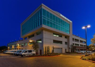 A large building with a lot of windows is lit up at night.