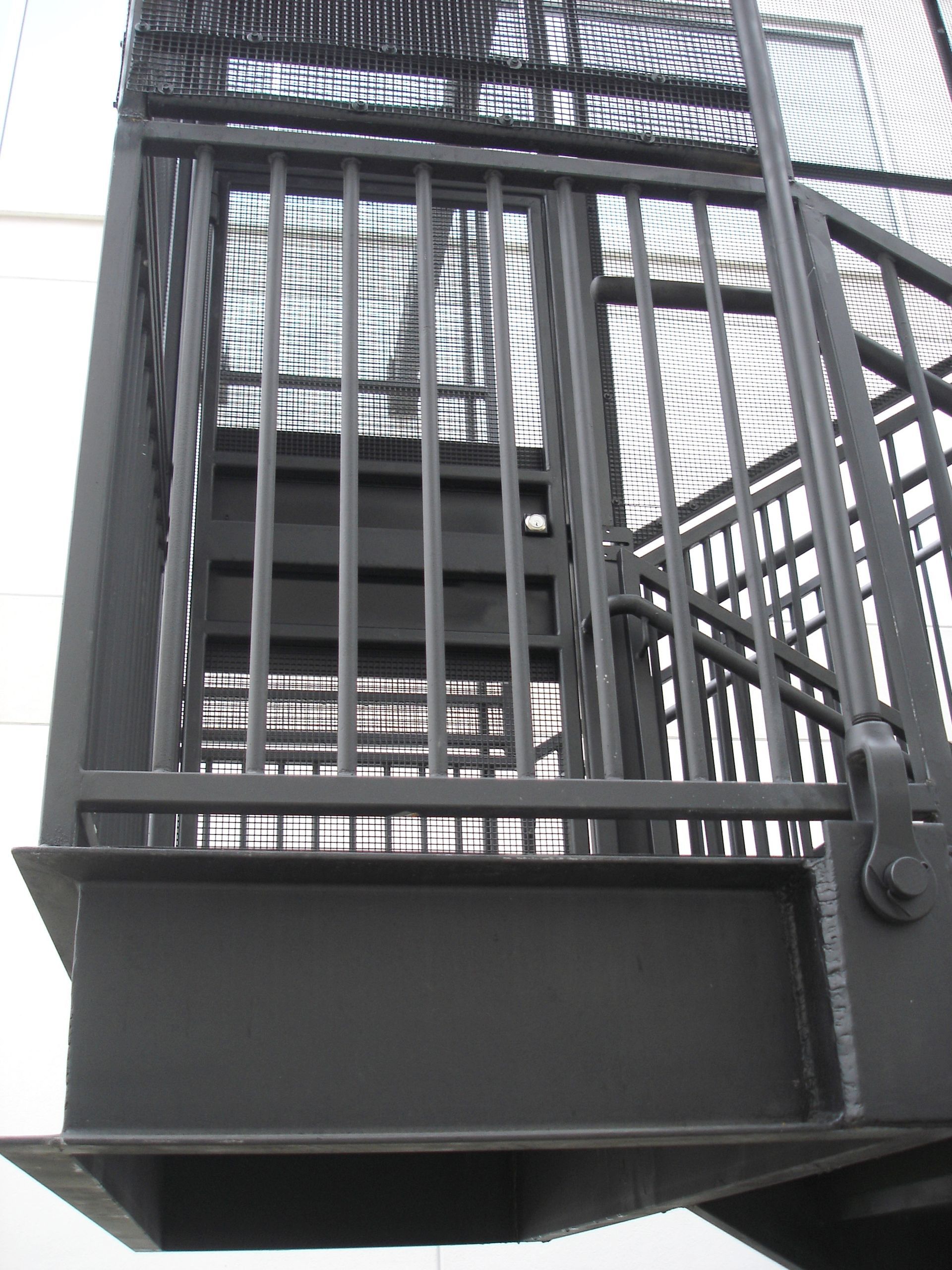 A close up of a metal staircase with bars on it