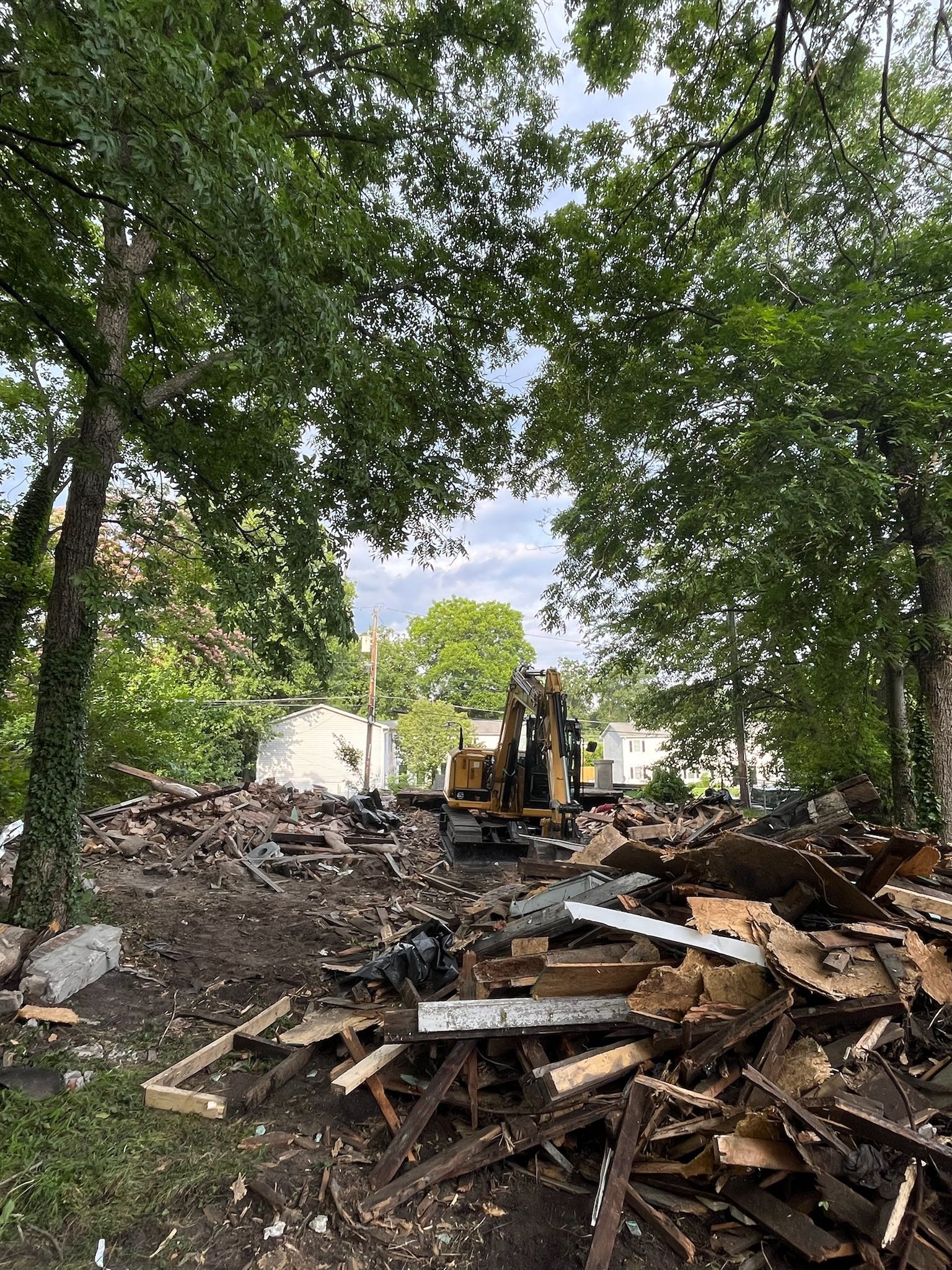 Two men discussing in front a demolished house in Greensboro
