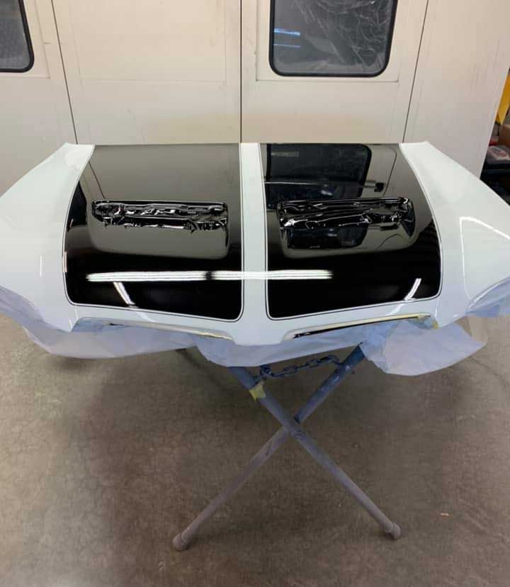 A black and white car hood is sitting on a table.