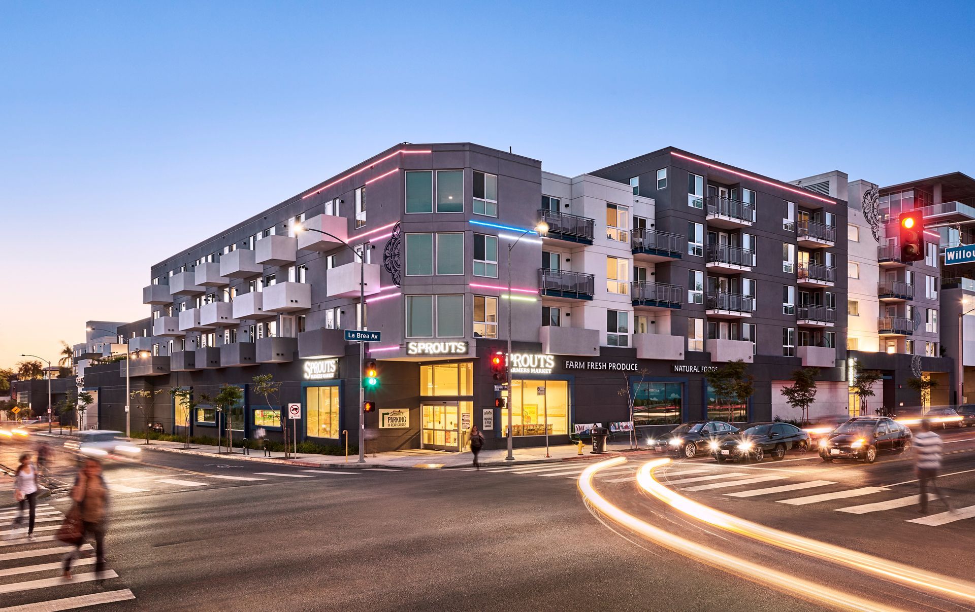 A group of people are sitting at a table writing in notebooks