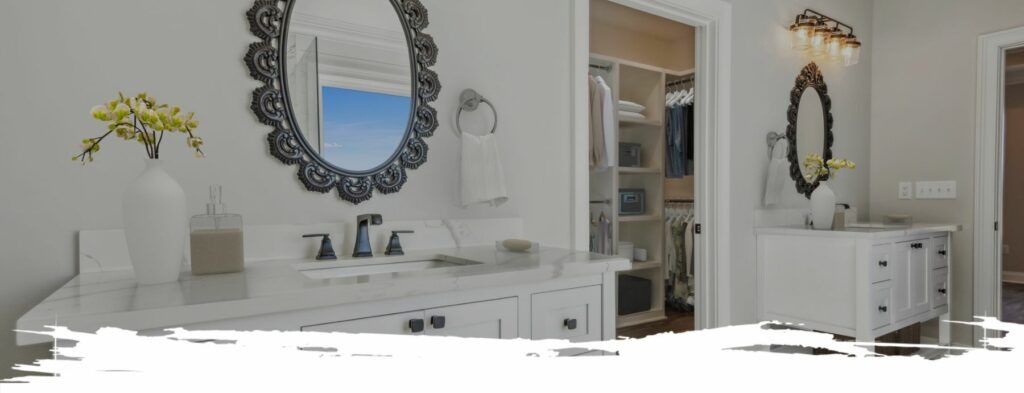 Bathroom with white vanity, ornate mirrors, and a closet.