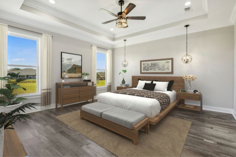Spacious bedroom with wood furniture, large windows, and a ceiling fan.