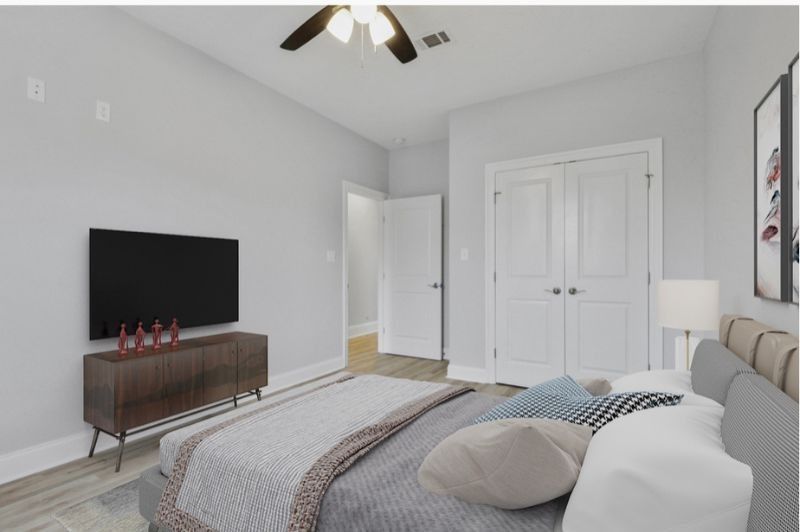 Bedroom with a bed, TV, wooden cabinet, white doors, and a ceiling fan.