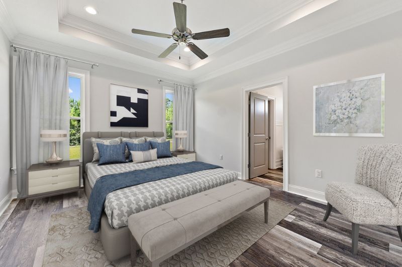 Bedroom with bed, bench, chair, artwork, and window; light gray and blue tones.