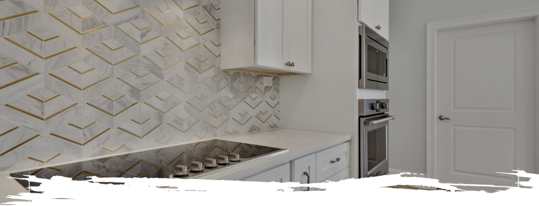Kitchen with white cabinets, a tiled backsplash, built-in appliances, and a closed door.