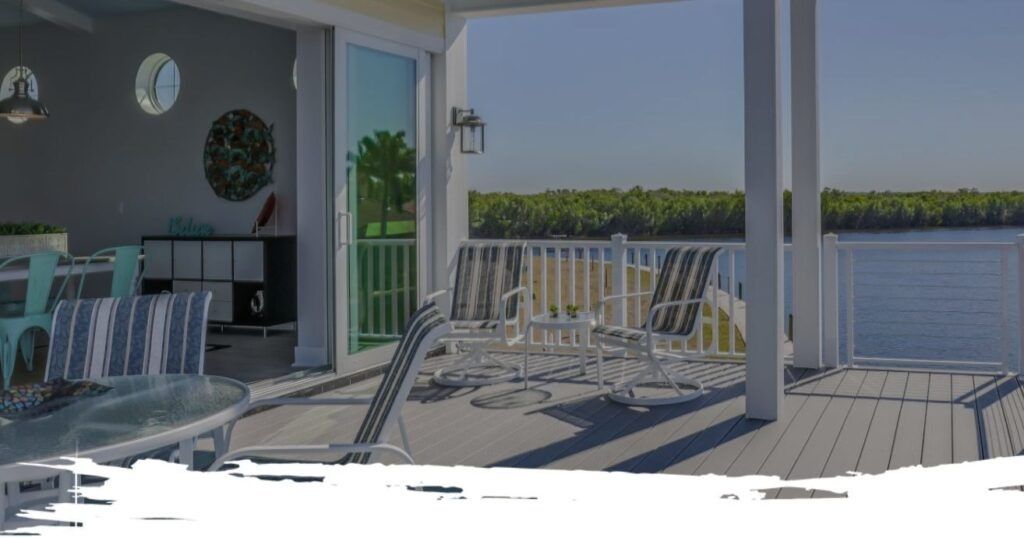 View from a deck overlooking water; chairs and table on the deck, interior with dining table visible.