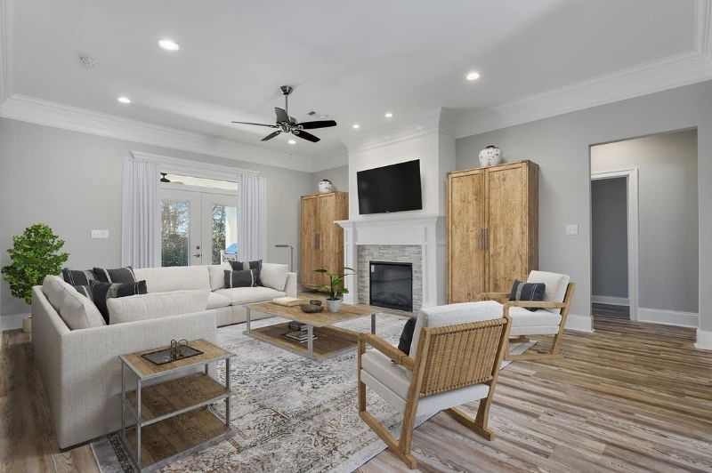 Spacious living room with fireplace, light furniture, and wood accents.