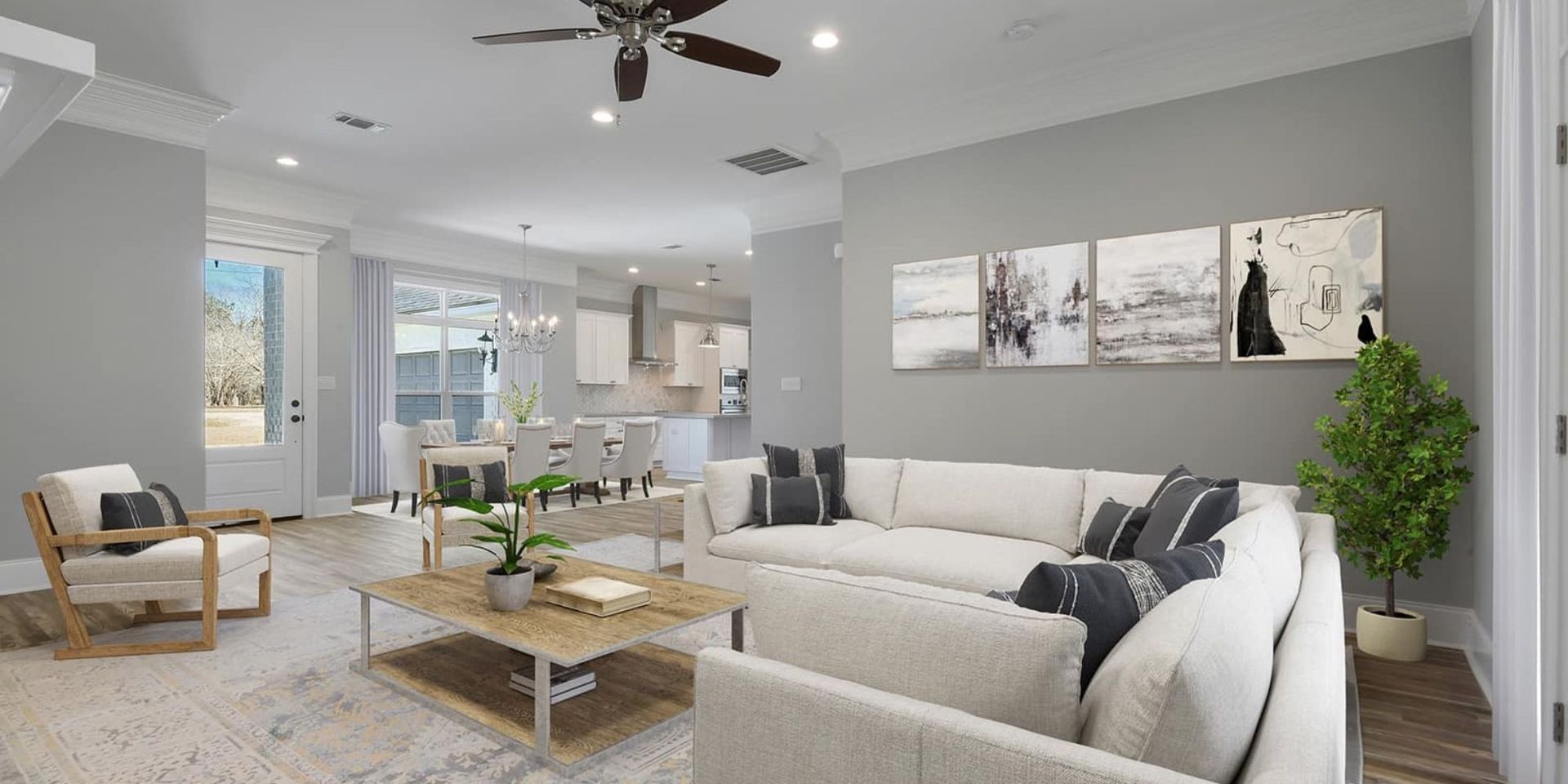 Living room with a white couch, art, and a houseplant.