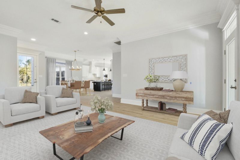 Bright living room with white furniture, wood coffee table, and neutral decor.