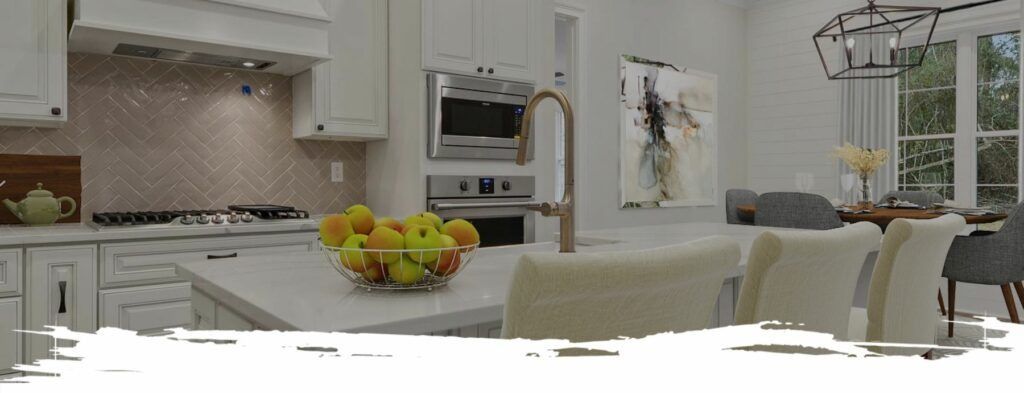 Modern kitchen with white cabinets, island, and dining area. Fruit bowl on island.