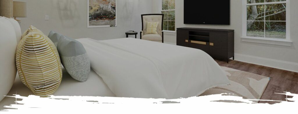 Bedroom with a white bed, pillows, TV, chair, and window.