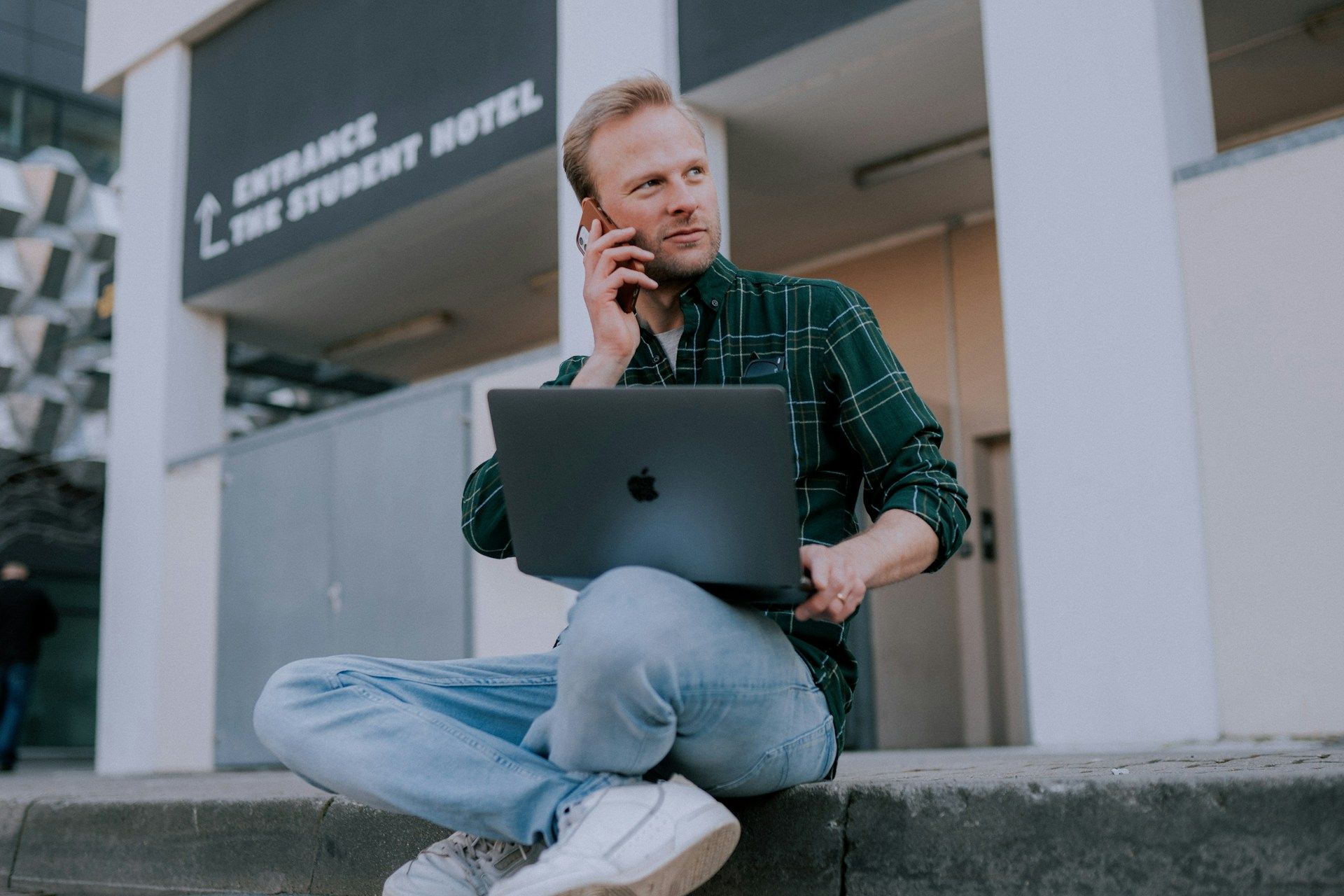 man with a laptop and on the phone