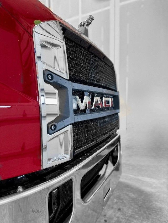 Red Mack truck front grill and logo.
