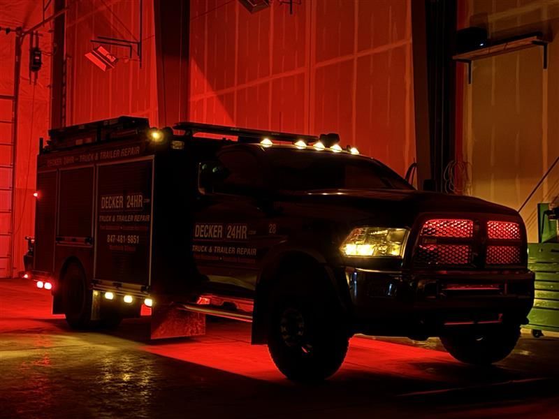 Dark emergency vehicle with flashing lights, parked inside a garage, illuminated by red and yellow lights. Dark emergency vehicle with flashing lights, parked inside a garage, illuminated by red and yellow lights.