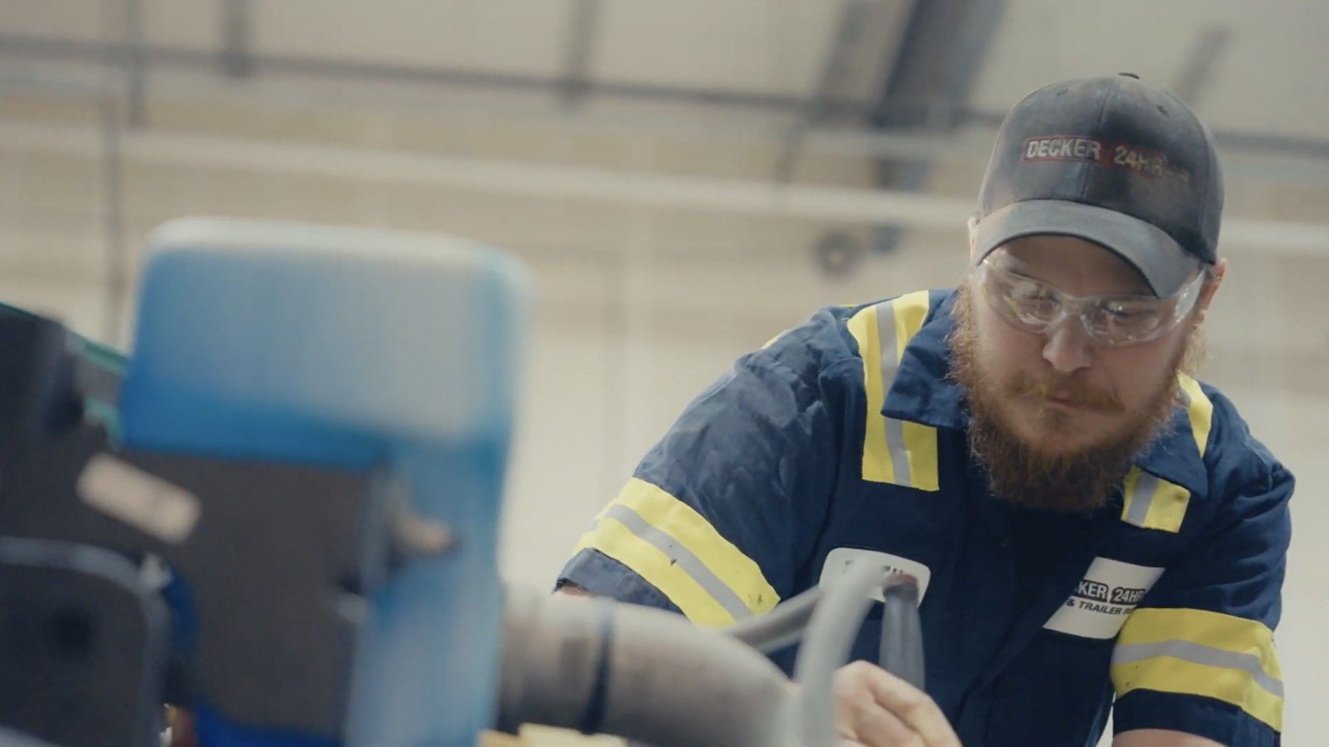 RV and van on a flatbed tow truck on a highway, with damage to the RV.