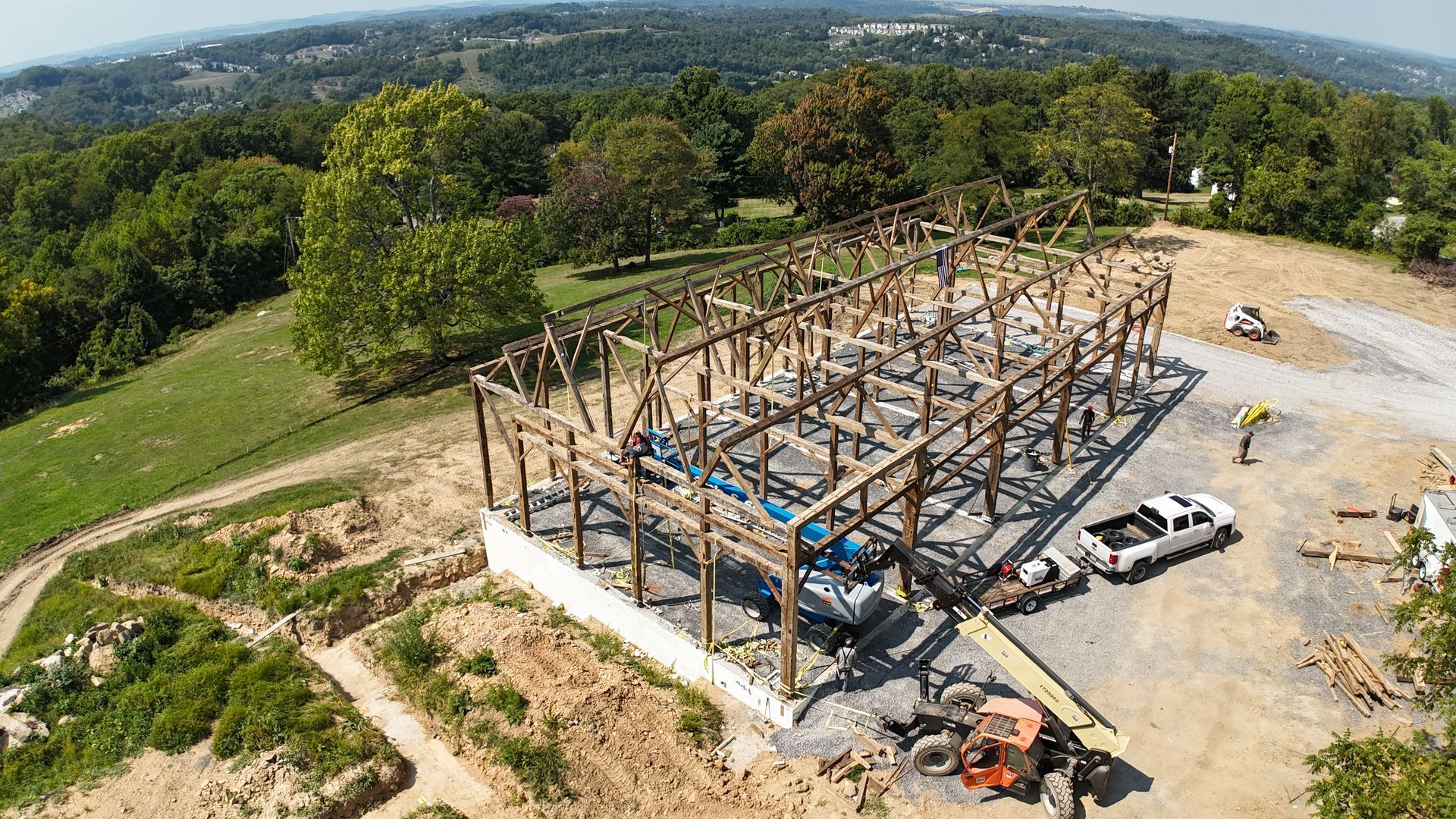 An aerial view of a building under construction in a field.