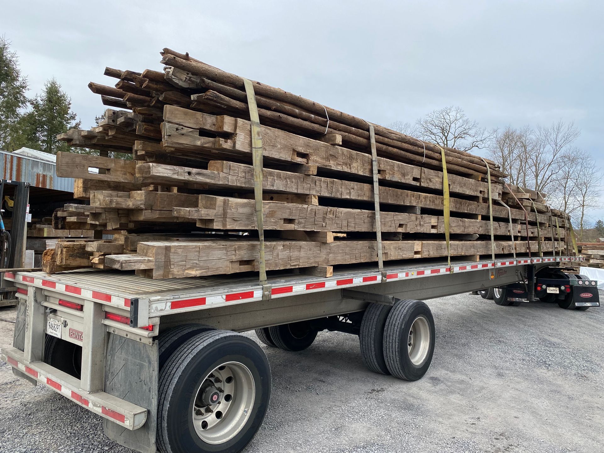 A living room with stairs leading up to the second floor and a couch.