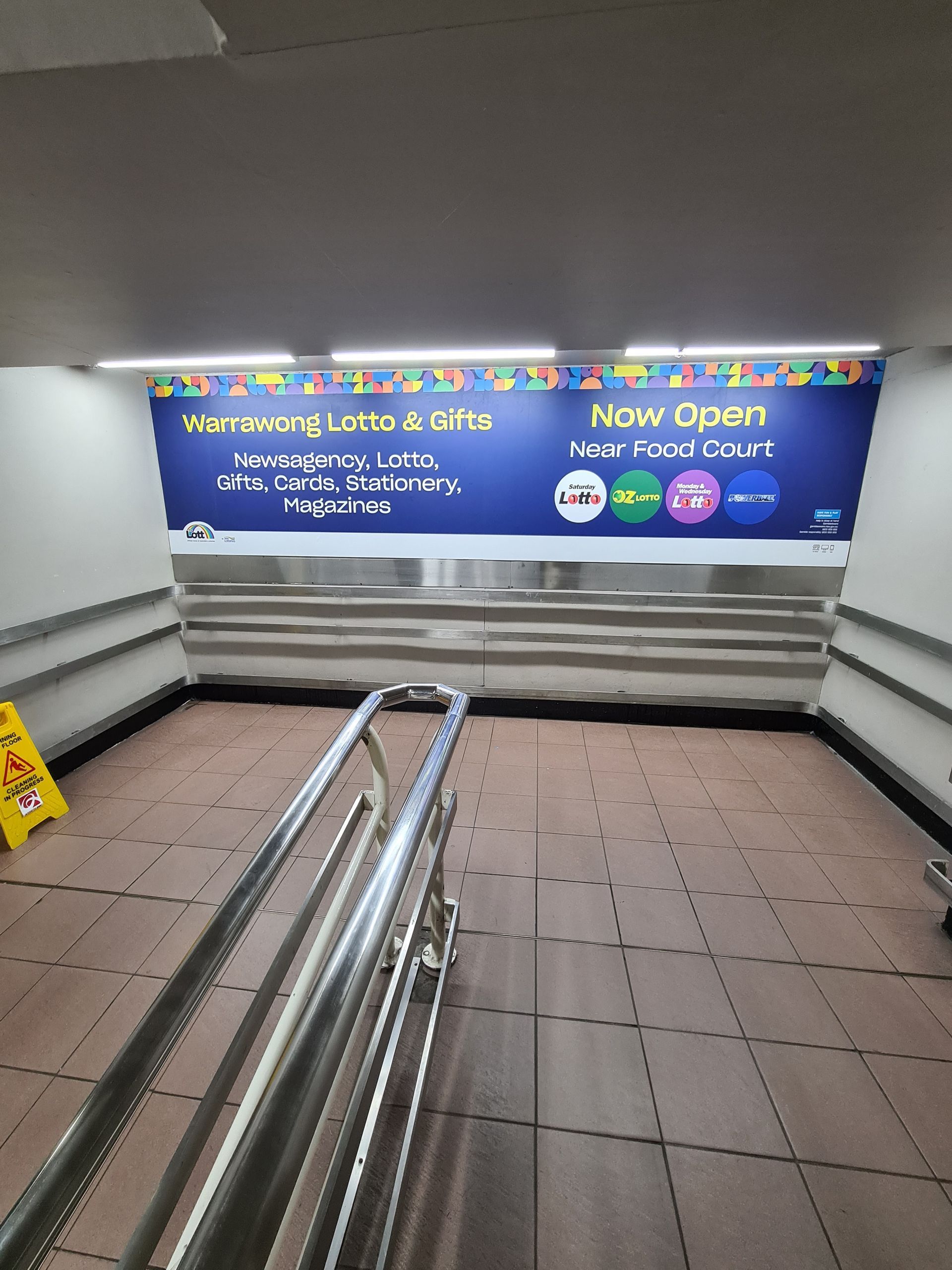 There is a sign on the wall that says `` now open ''-Professional Signwriter in the Illawarra