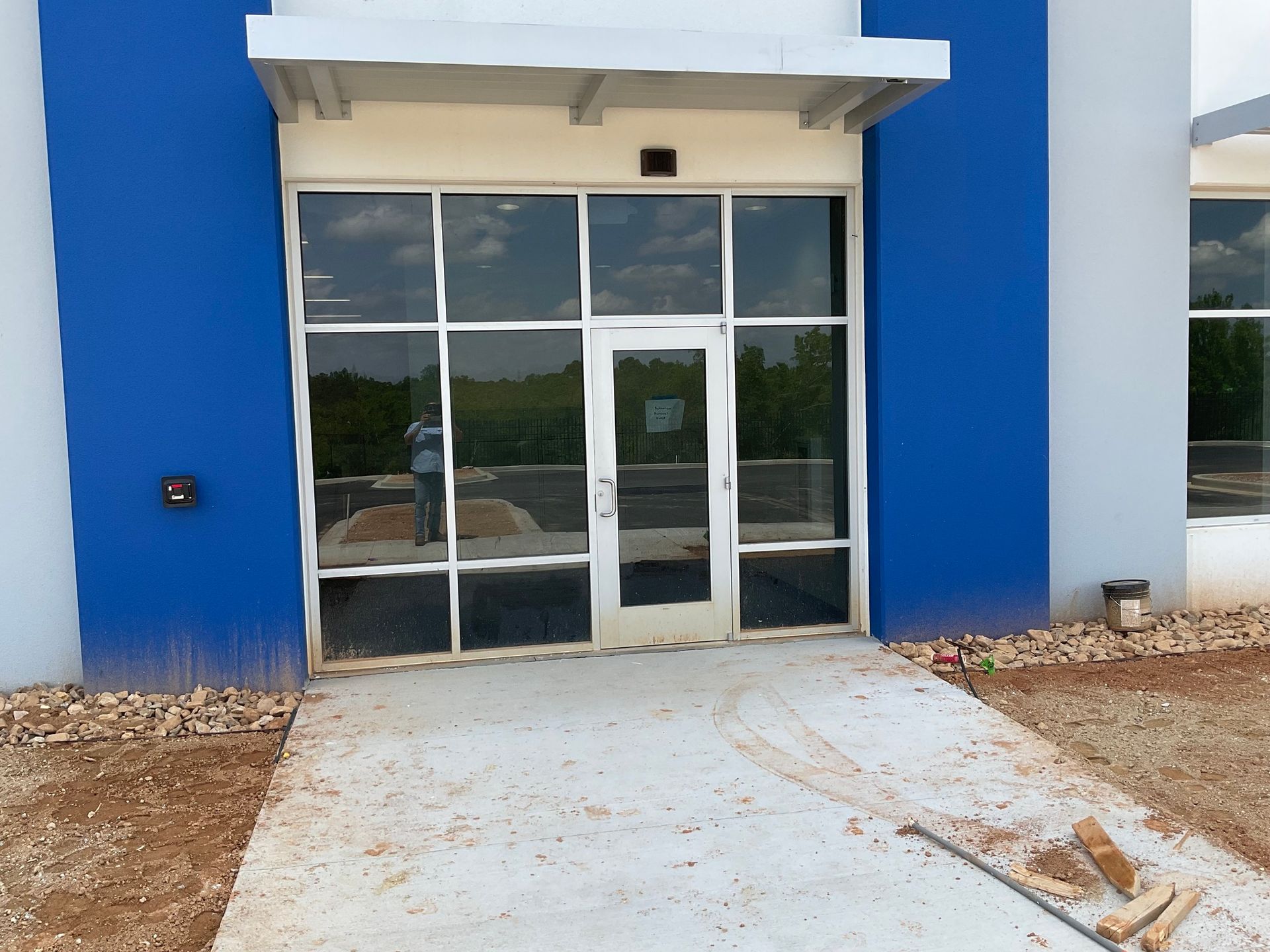 A blue and white building with a glass door