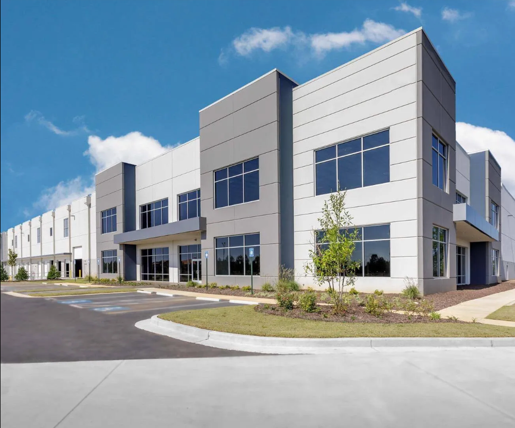 A large building with a lot of windows on a sunny day