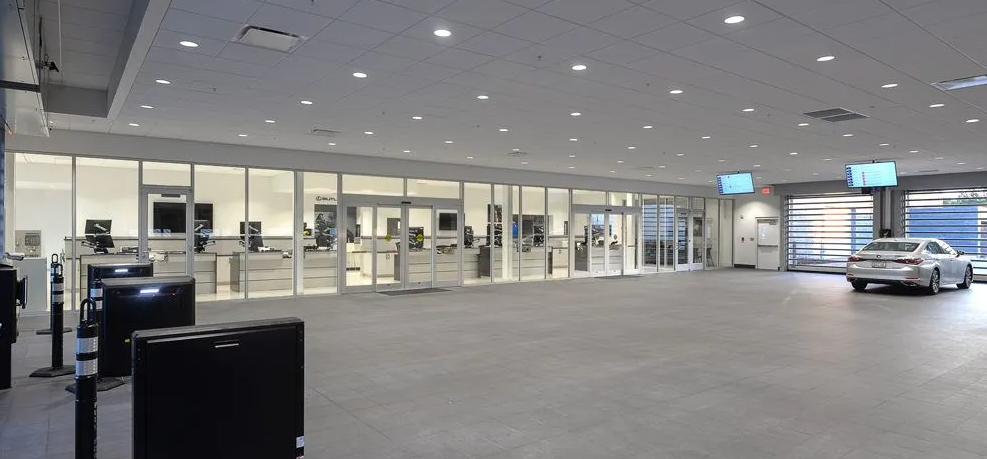 A car is parked in a garage in a car dealership.