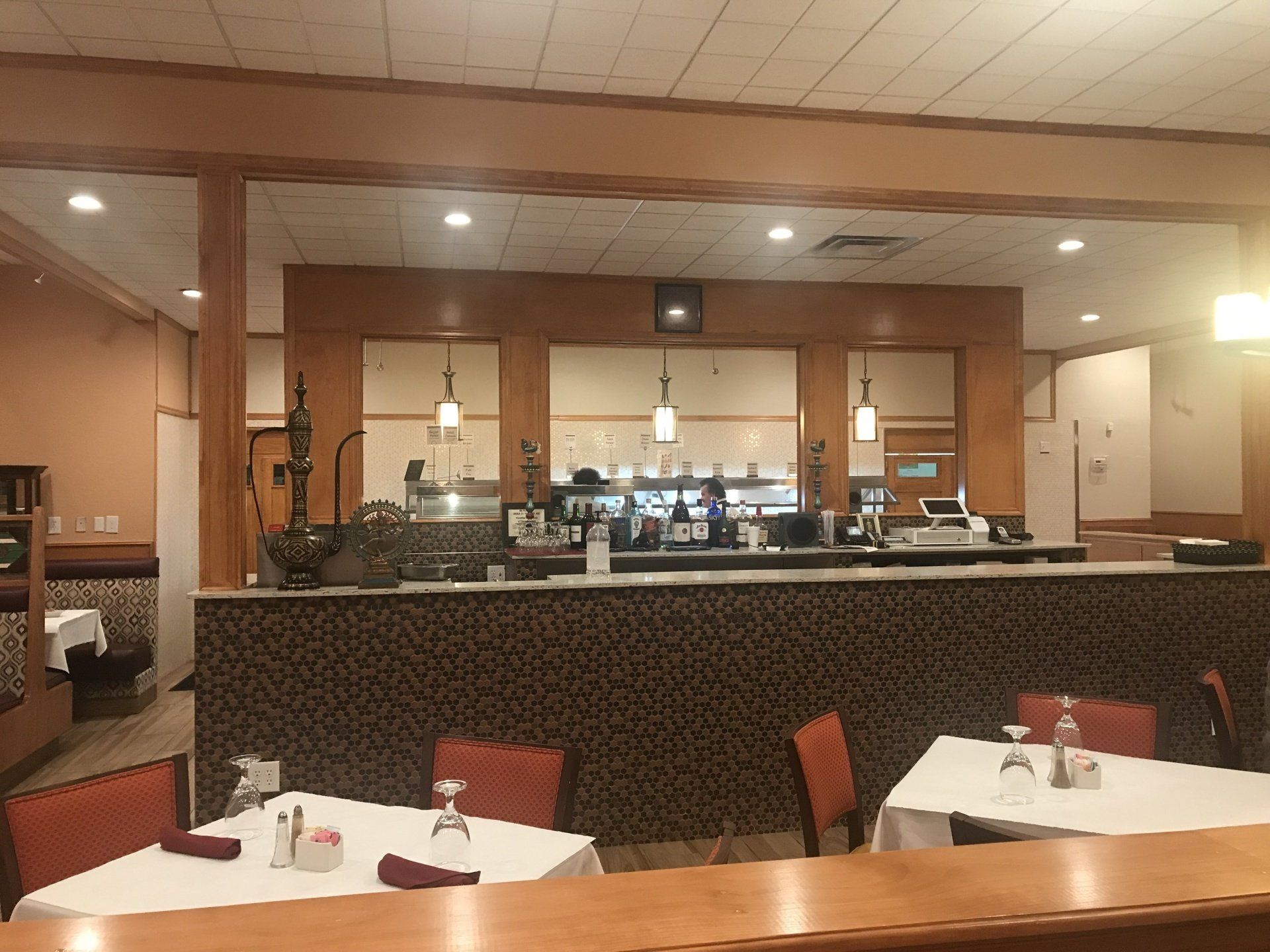A restaurant with tables and chairs and a bar