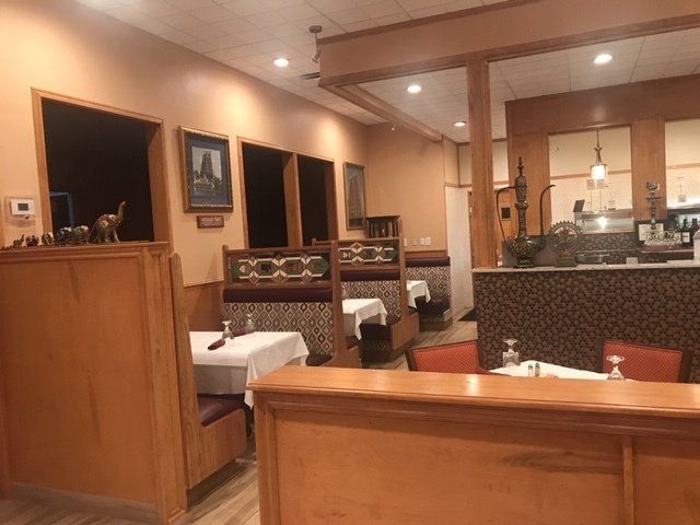 The inside of a restaurant with tables and chairs