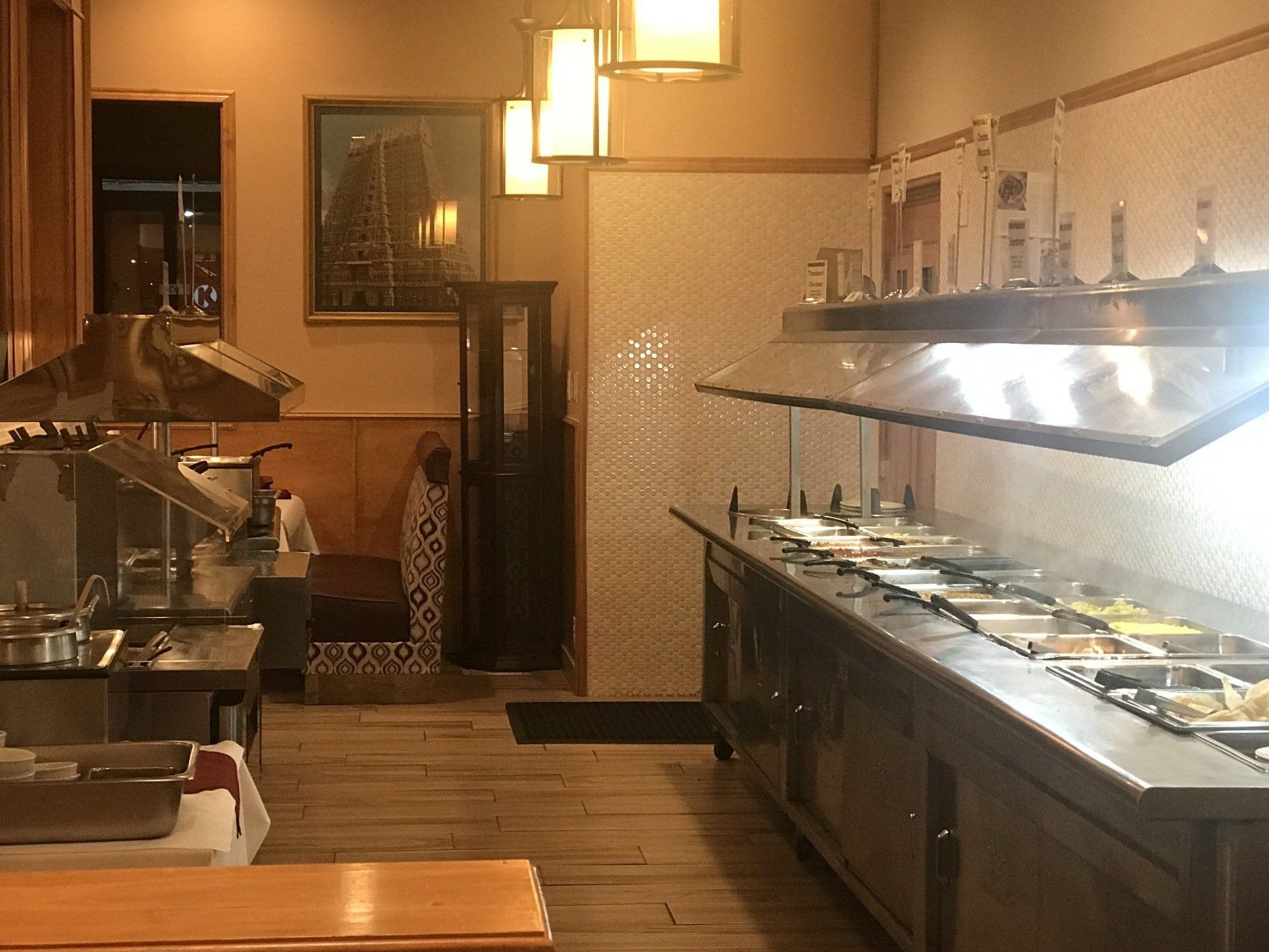 A buffet line in a restaurant with a lot of food on it.