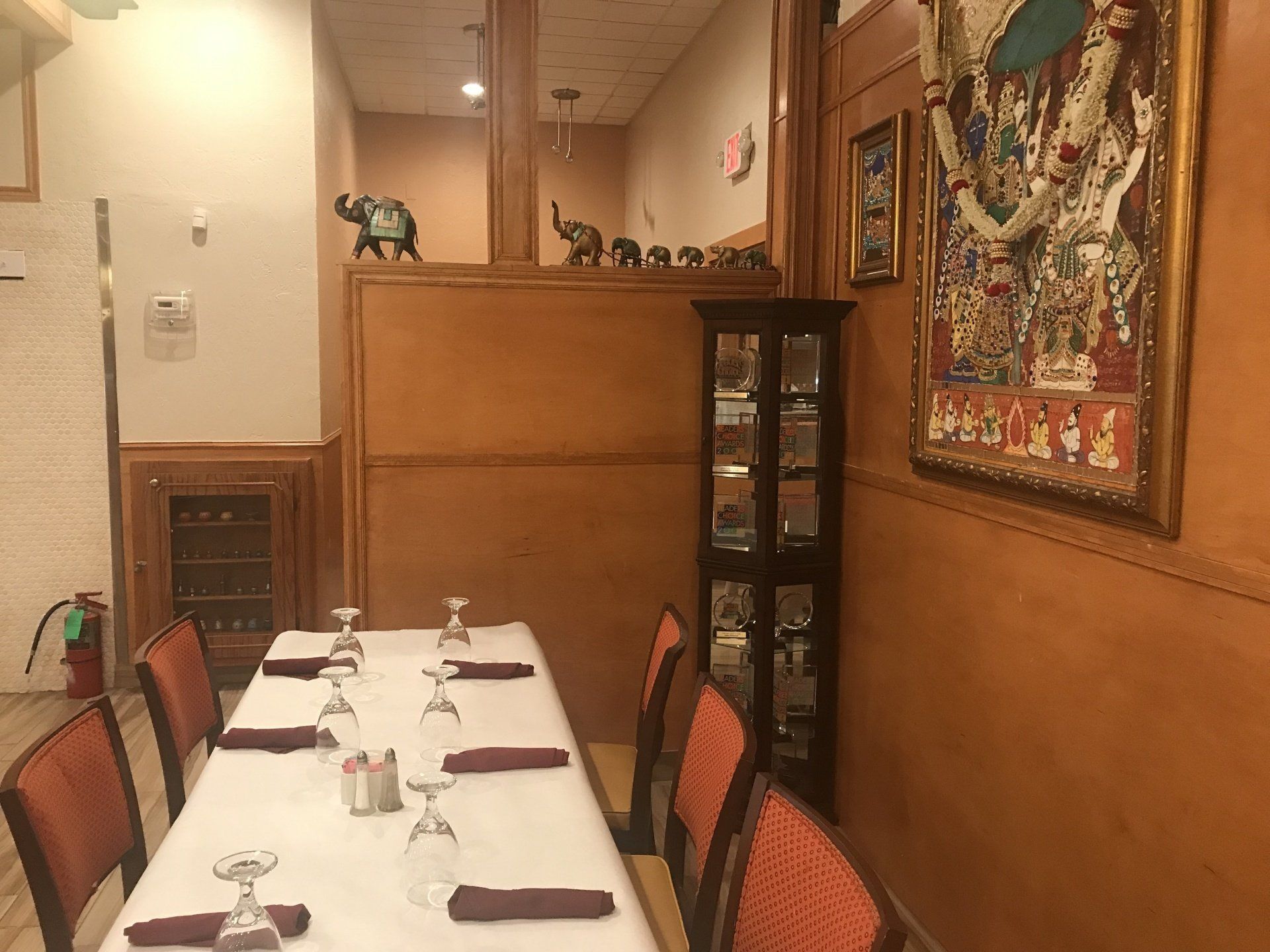 A long table with wine glasses on it in a restaurant.