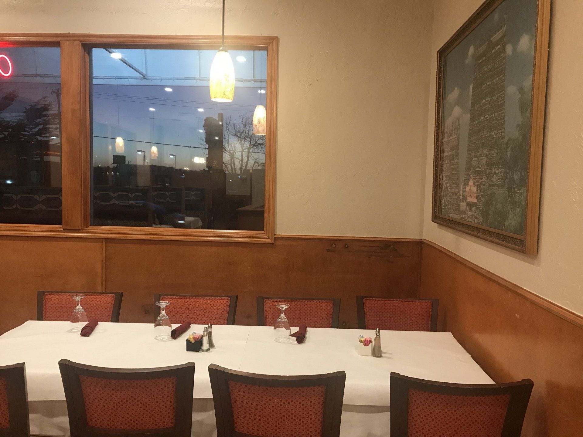A dining room with tables and chairs and a window