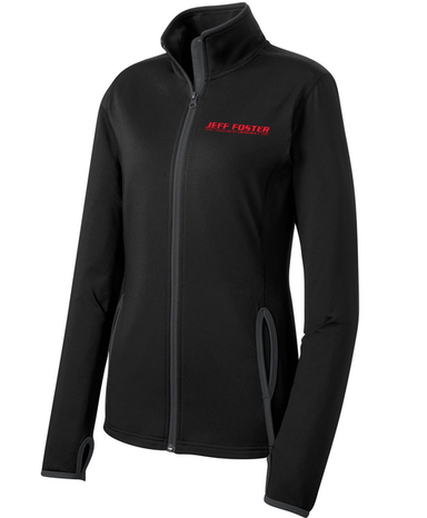 A woman is wearing a black jacket with a red logo on the front.