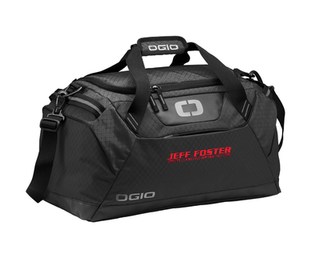 A black duffel bag that says ogio on it