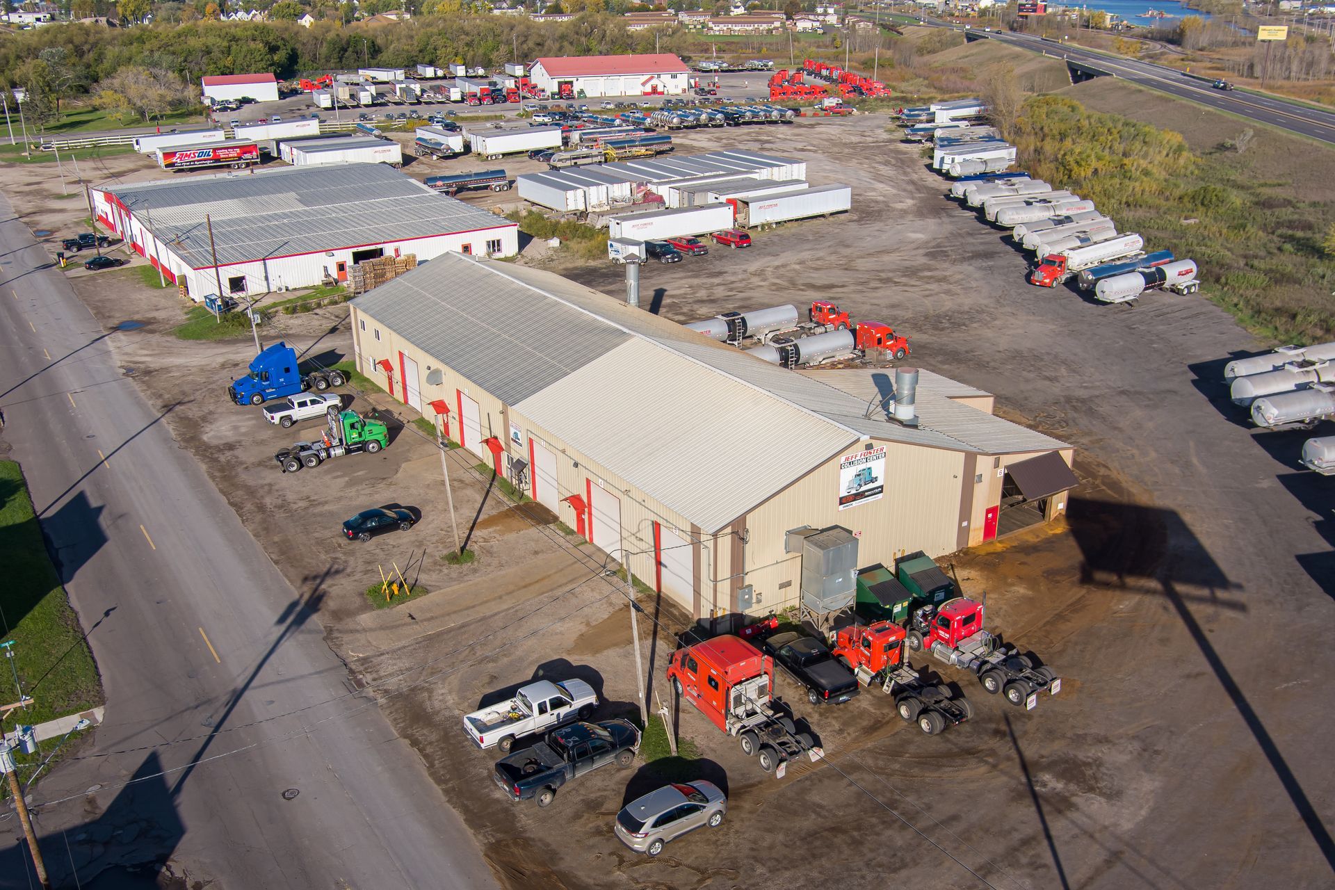 an aerial view of a large warehouse with trucks parked in front of it .