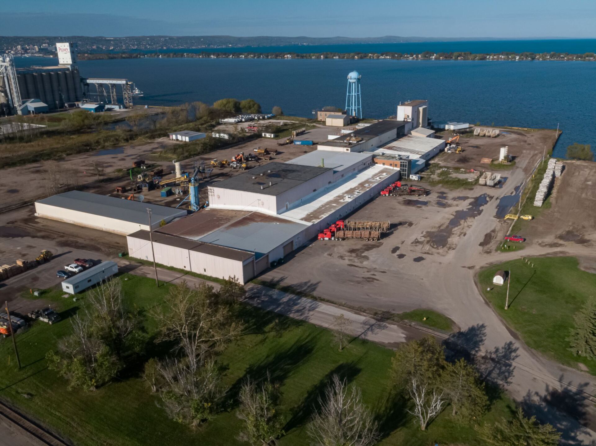 An aerial view of a large building next to a body of water.