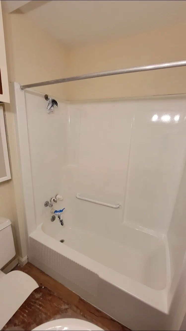 Freshly remodeled bathtub area with clean white acrylic. Freshly remodeled bathtub area with clean white acrylic.