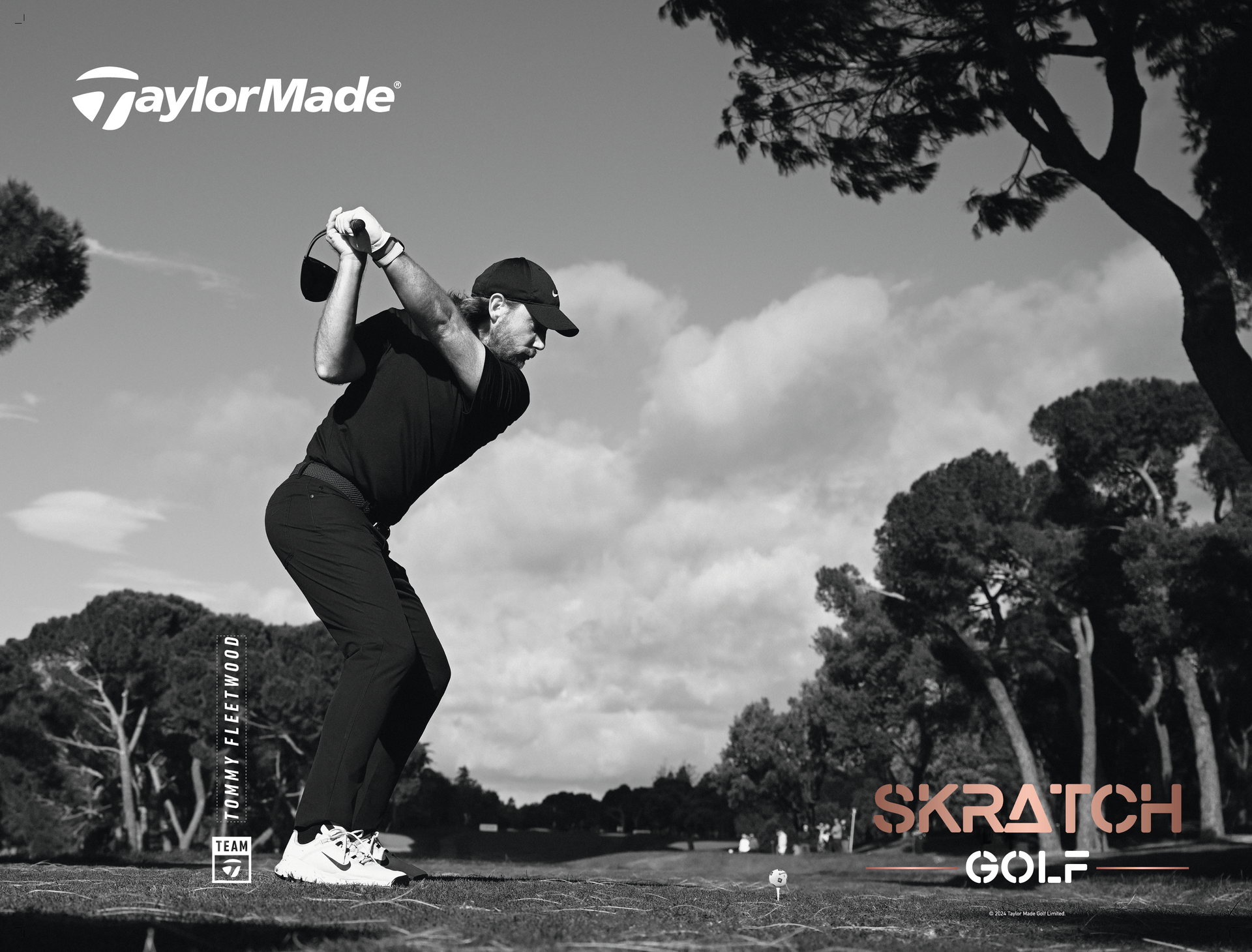 Black and white photo of a golfer mid-swing on a course. TaylorMade logo at the top.
