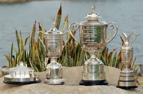 Two women clink glasses of amber-colored drinks at a dimly lit bar, smiling and toasting.