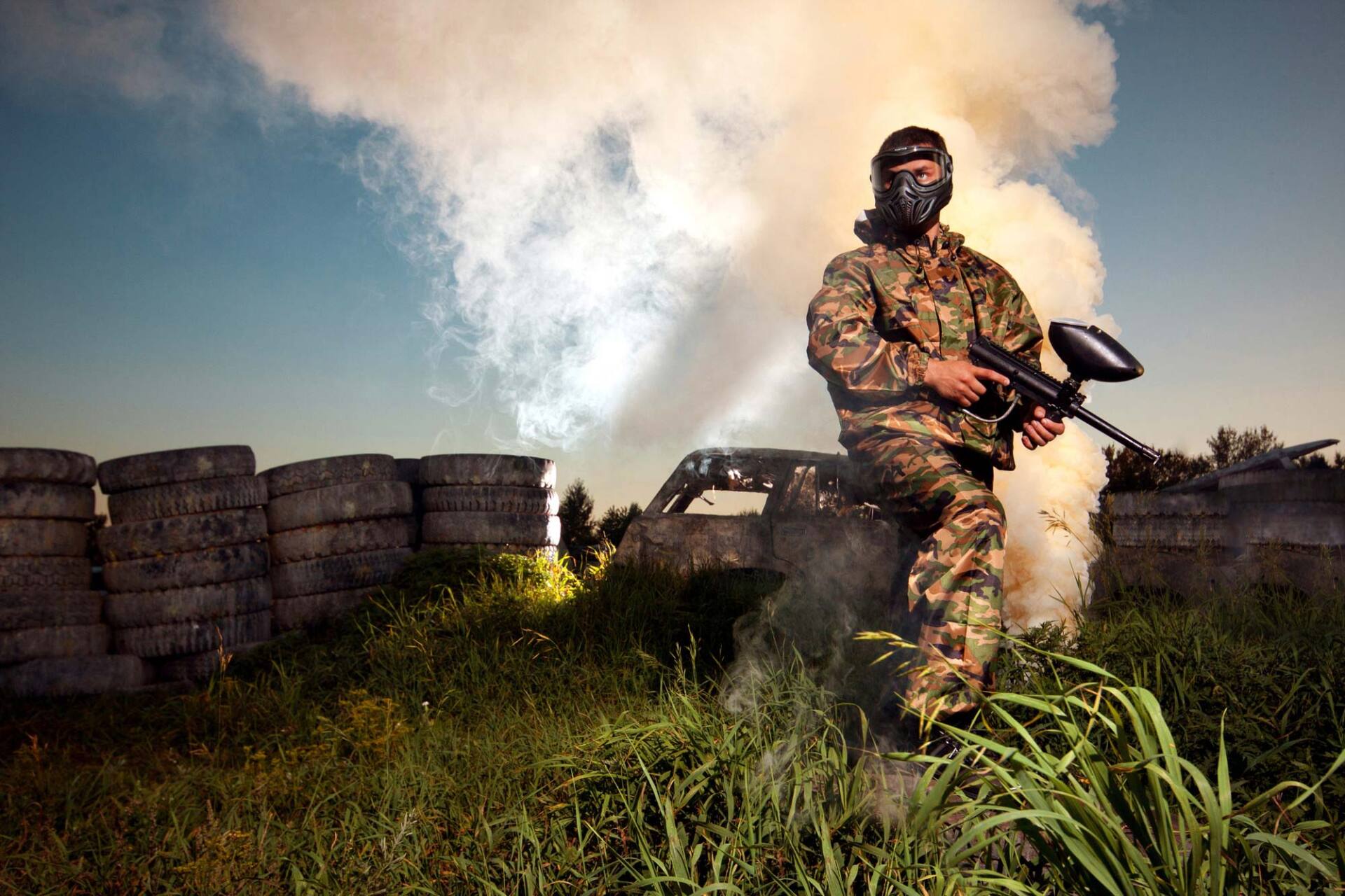 tyres, smoke and a person with paintball full gear on