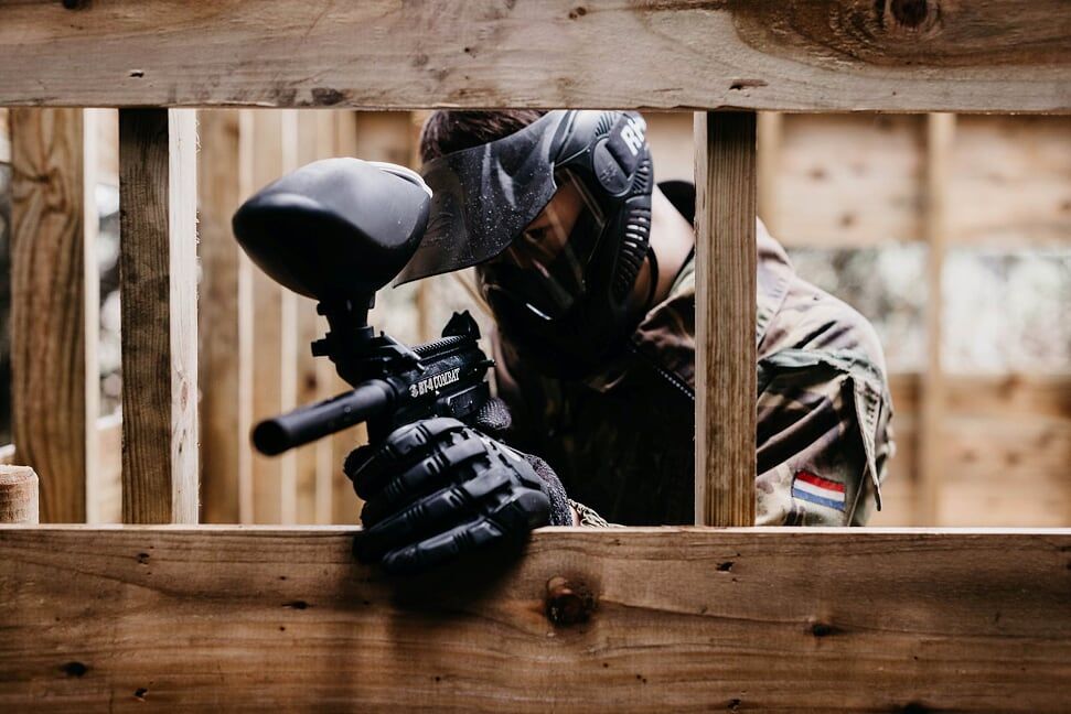 Paintball gamer, soldier running to get cove