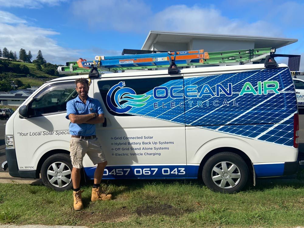 Man Standing Next to Ocean Air Electrical Vehicle — Ocean Air Electrical in Lismore, NSW