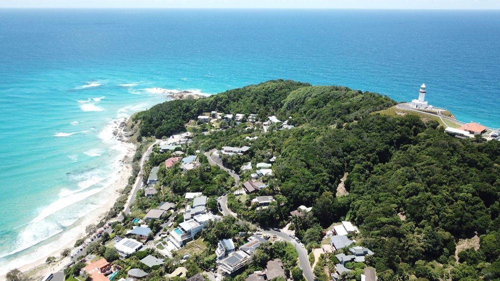 An Aerial View of a Residential Area Next to the Ocean — Ocean Air Electrical in Byron Bay, NSW
