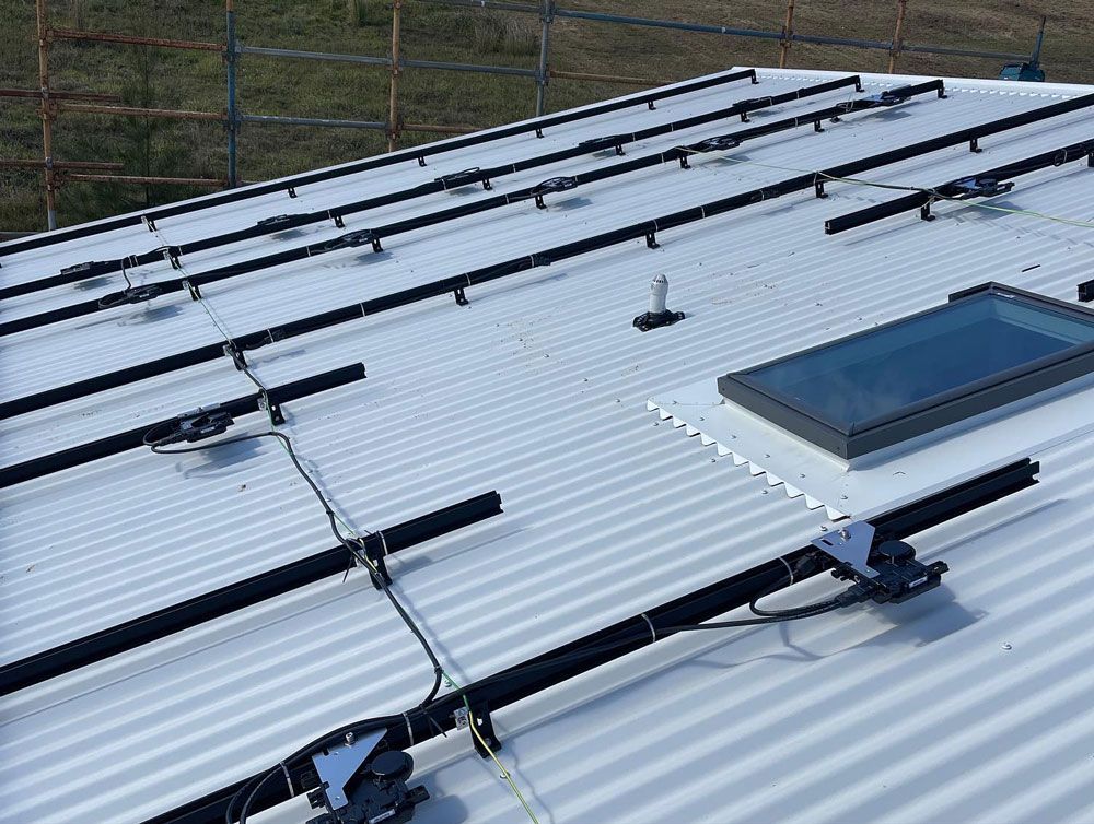 A Roof With a Skylight and Solar Panels on It — Ocean Air Electrical in Byron Bay, NSW