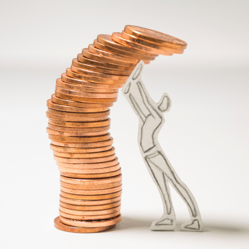 A silhouette of a person holding up a stack of coins.