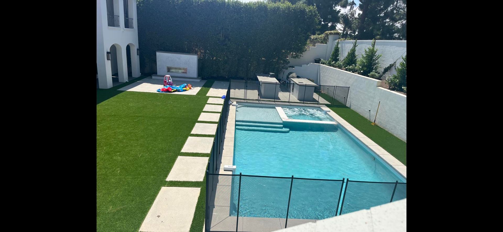 A large swimming pool in the backyard of a house